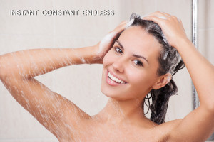 Young woman washing her head in the shower by shampoo